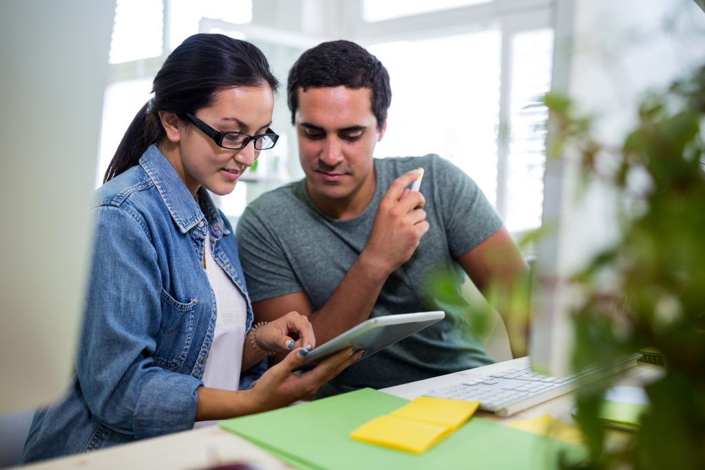male and female graphic designers using digital tablet